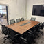 Meeting room with modern chandelier, TV, and view into RŌST Coffee
