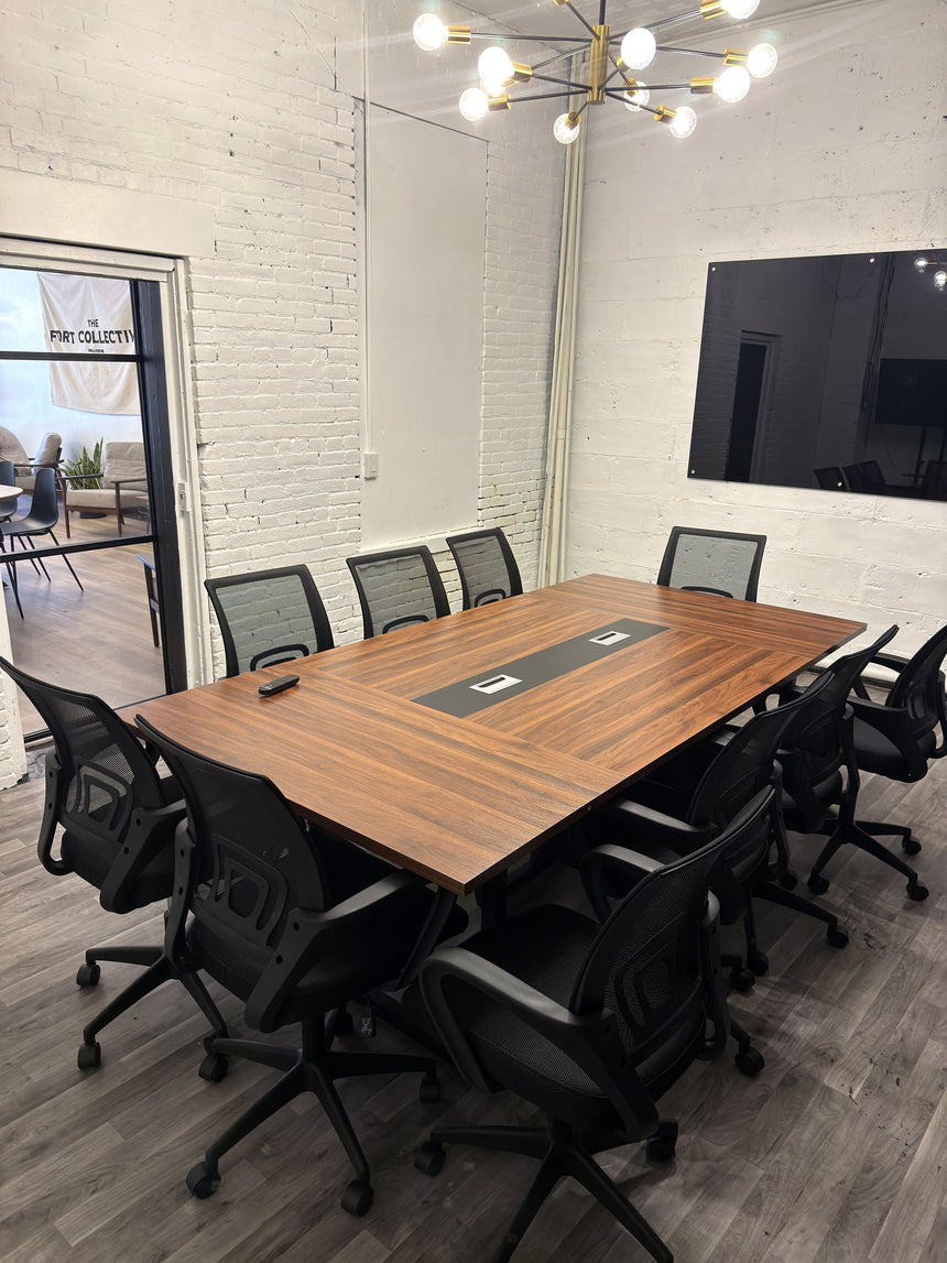 Meeting room at RŌST Coffee in Chillicothe with 10-person walnut conference table and presentation TV