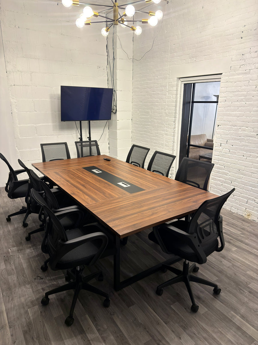 Meeting room at RŌST Coffee in Chillicothe with 10-person walnut conference table and presentation TV