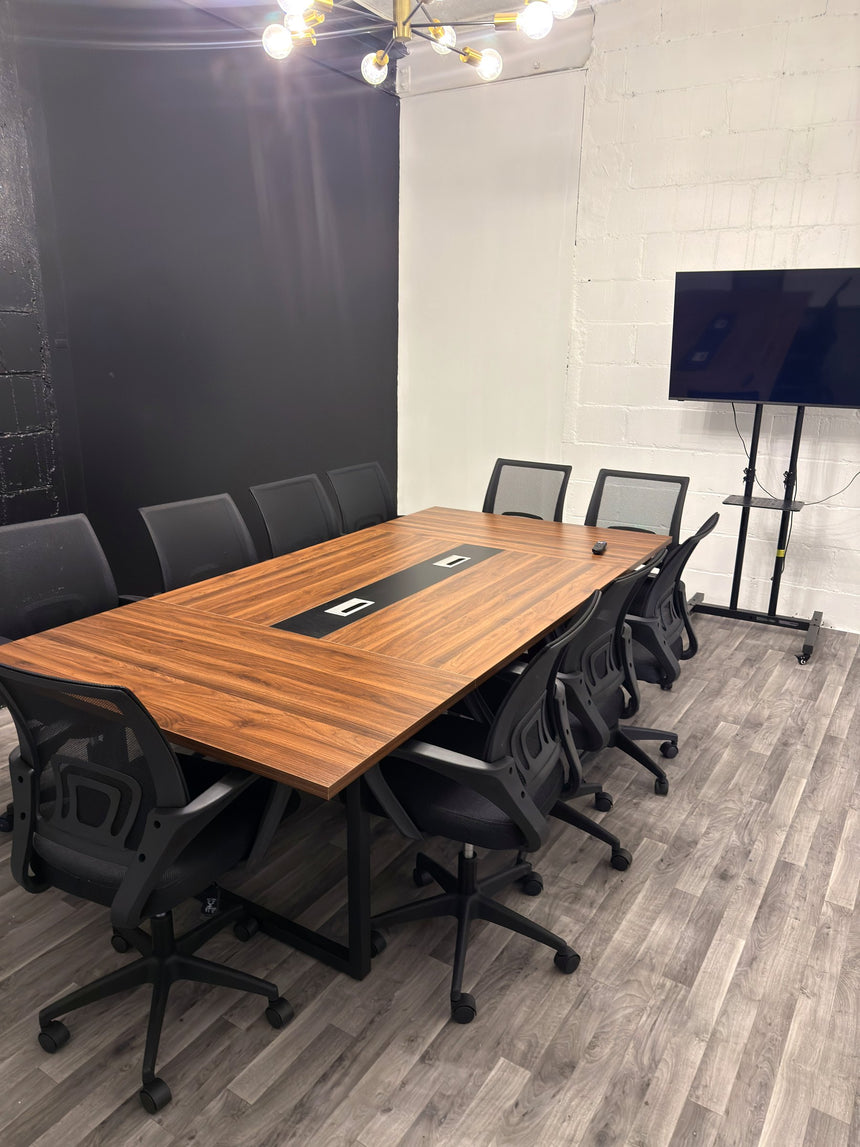 Meeting room at RŌST Coffee in Chillicothe with 10-person walnut conference table and presentation TV