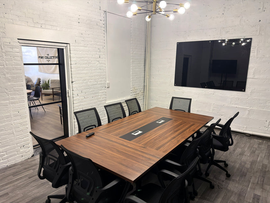 Meeting room at RŌST Coffee in Chillicothe with 10-person walnut conference table and presentation TV