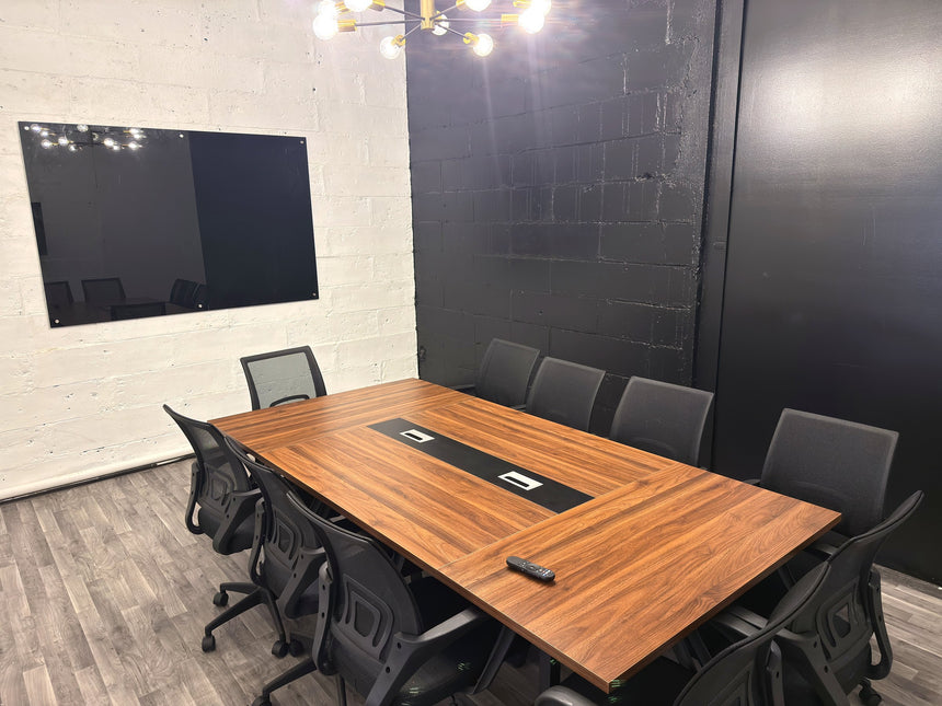 Meeting room at RŌST Coffee in Chillicothe with 10-person walnut conference table and presentation TV