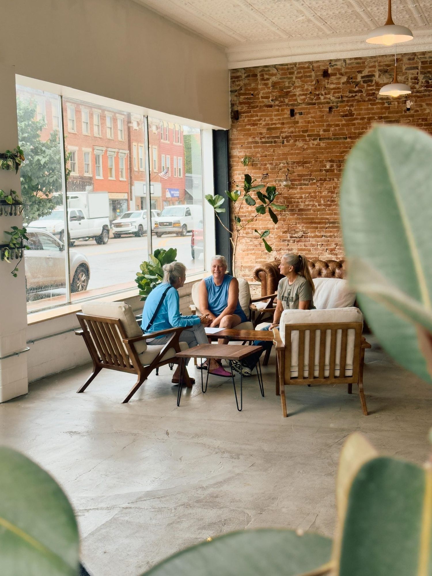 Customers talking in armchairs by the window at RŌST Circleville