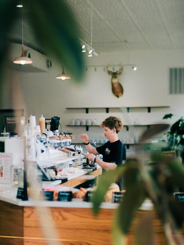 A barista pulling espresso behind the counter at RŌST Circleville